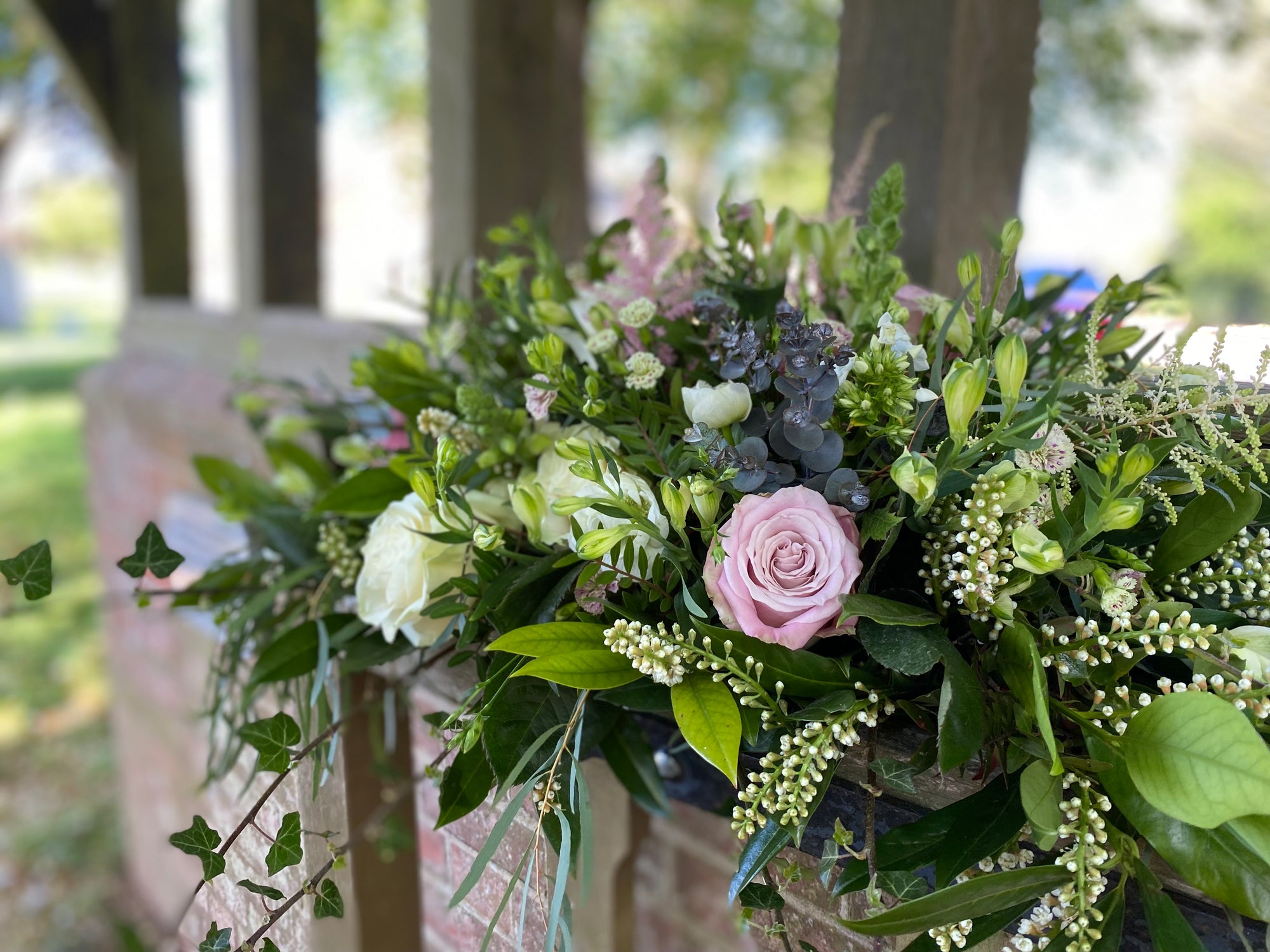 Coffin Spray of flowers with pink roses and greenery . Local Funeral Directors delivery Joannes Florist