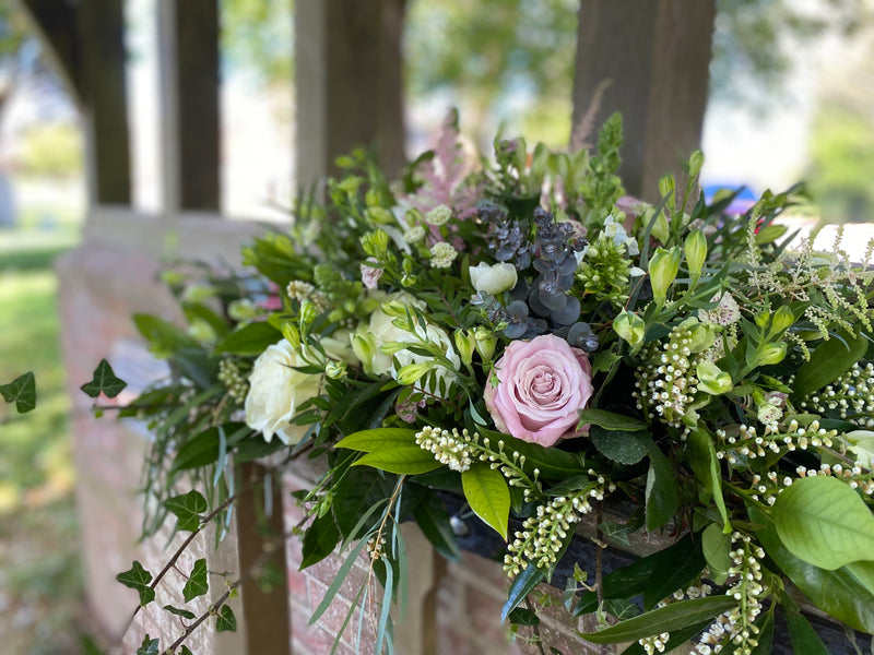 Coffin Spray of flowers with pink roses and greenery . Local Funeral Directors delivery Joannes Florist