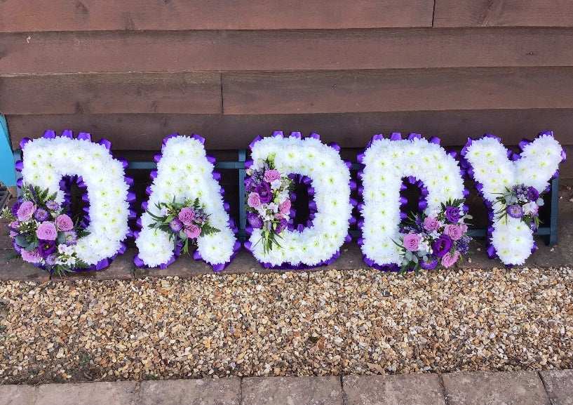 DADDY floral letter tribute in white chrysanthemums with purple ribbon edge and lilac rose sprays by The Petal Boutique