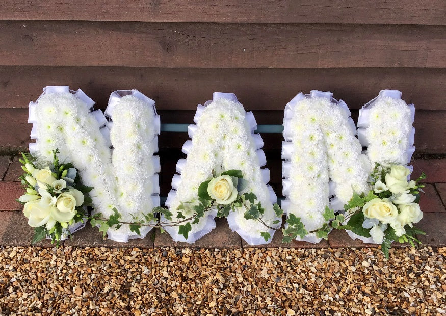 NAN floral letter tribute in white chrysanthemums with white roses and trailing ivy by The Petal Boutique