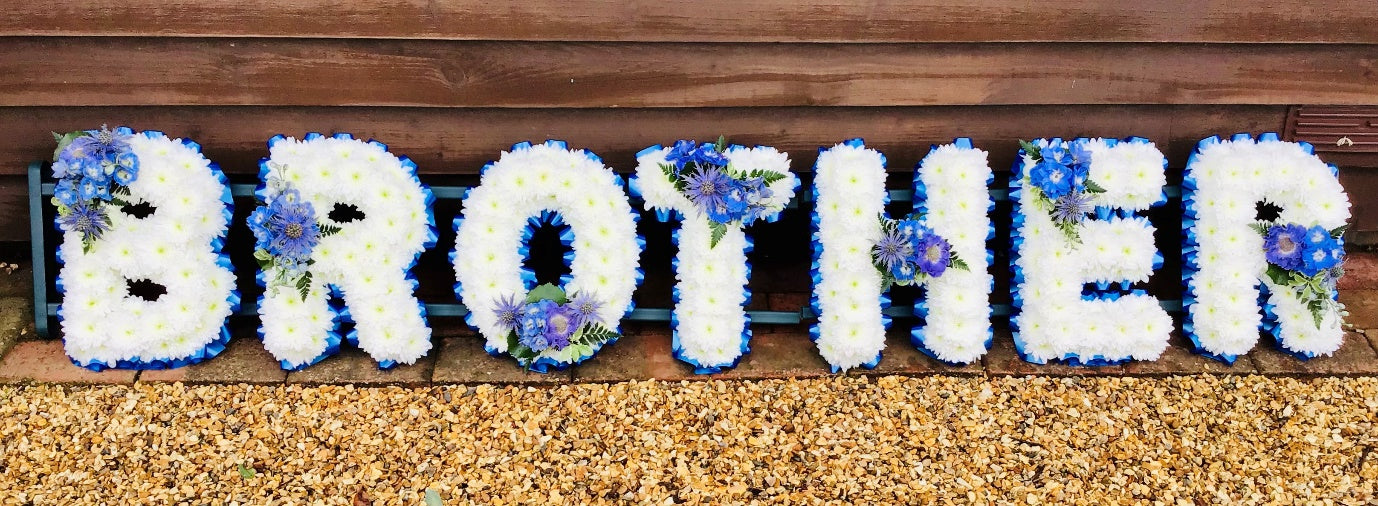 BROTHER floral letter tribute in white chrysanthemums with blue ribbon edge and blue flower sprays by The Petal Boutique