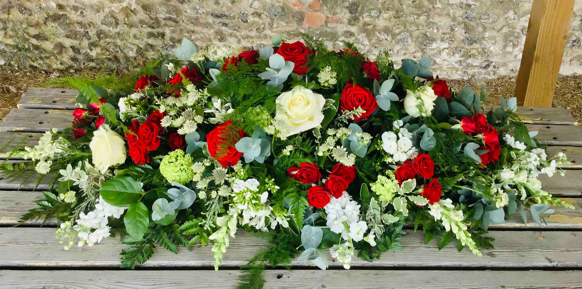 Red & White Casket Spray funeral tribute by The Petal Boutique Winchester